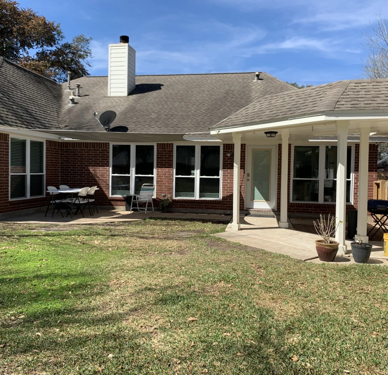 Sunny backyard with patio furniture