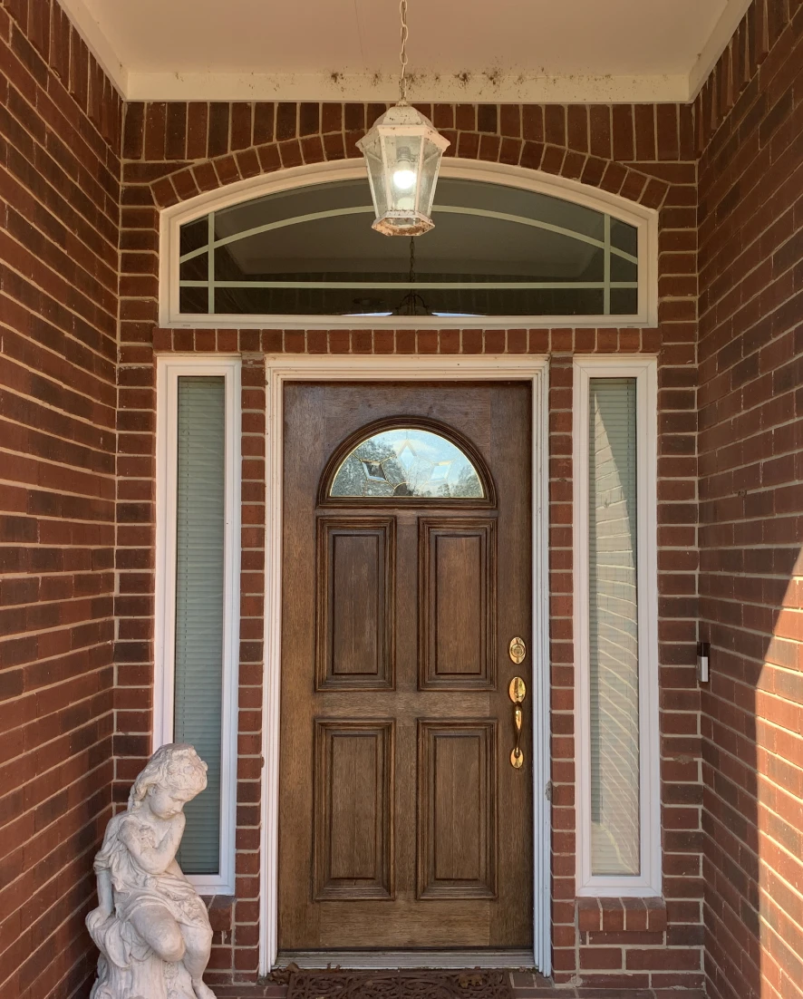 Arched window above wooden door