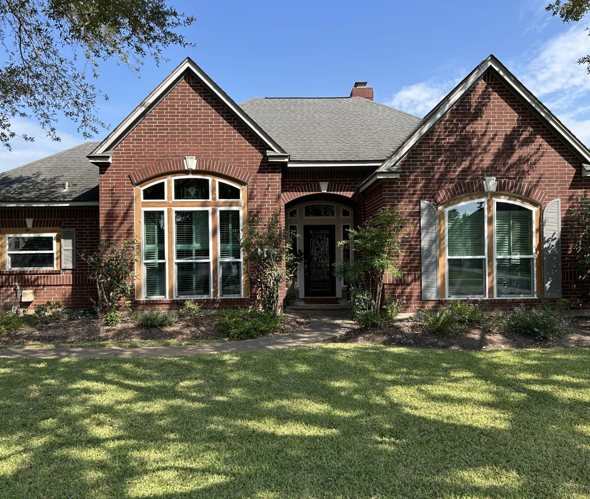 Red brick home under blue sky